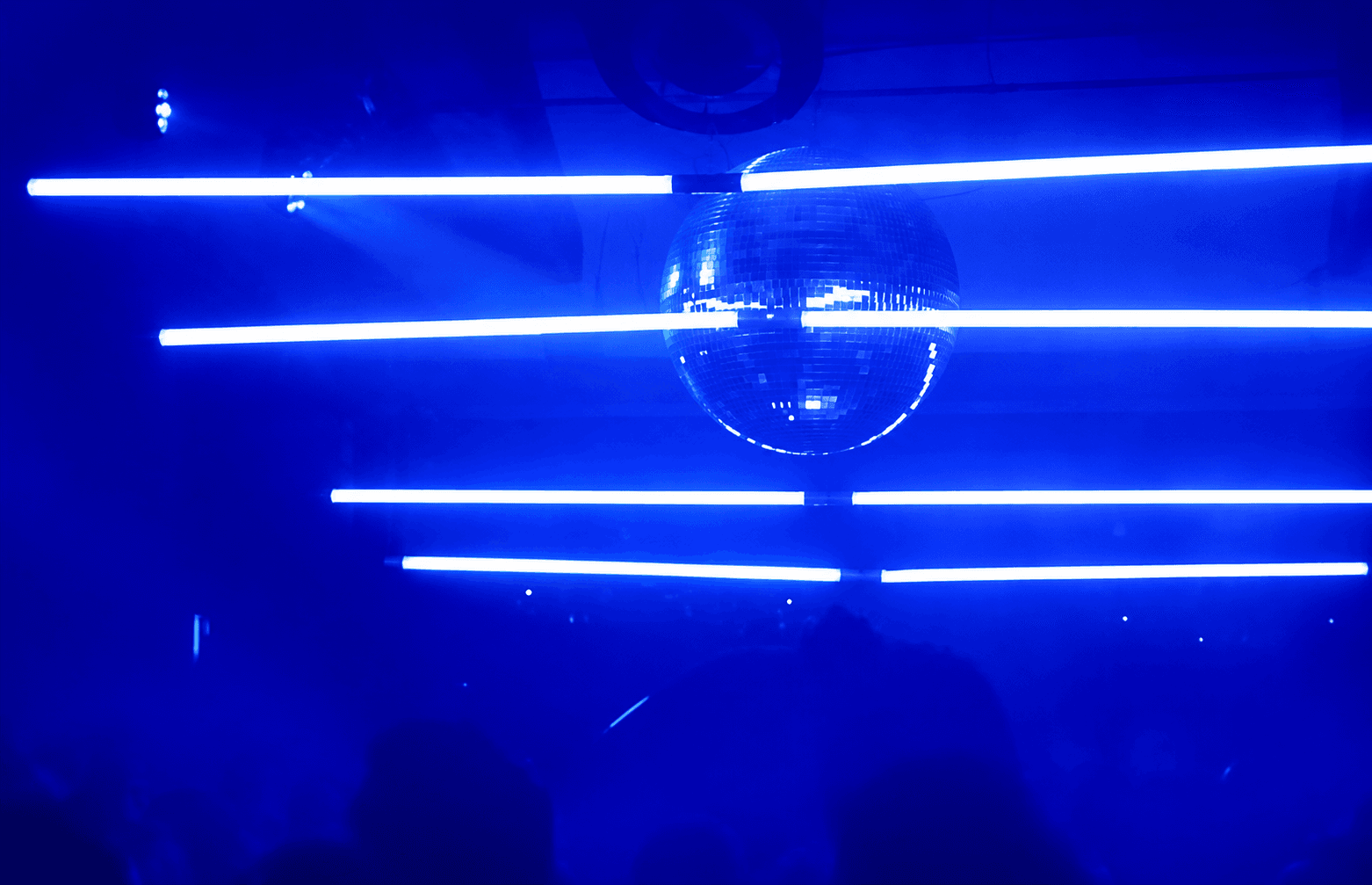 Blue lights and a disco ball on the Love na Casa Rosa dancefloor.