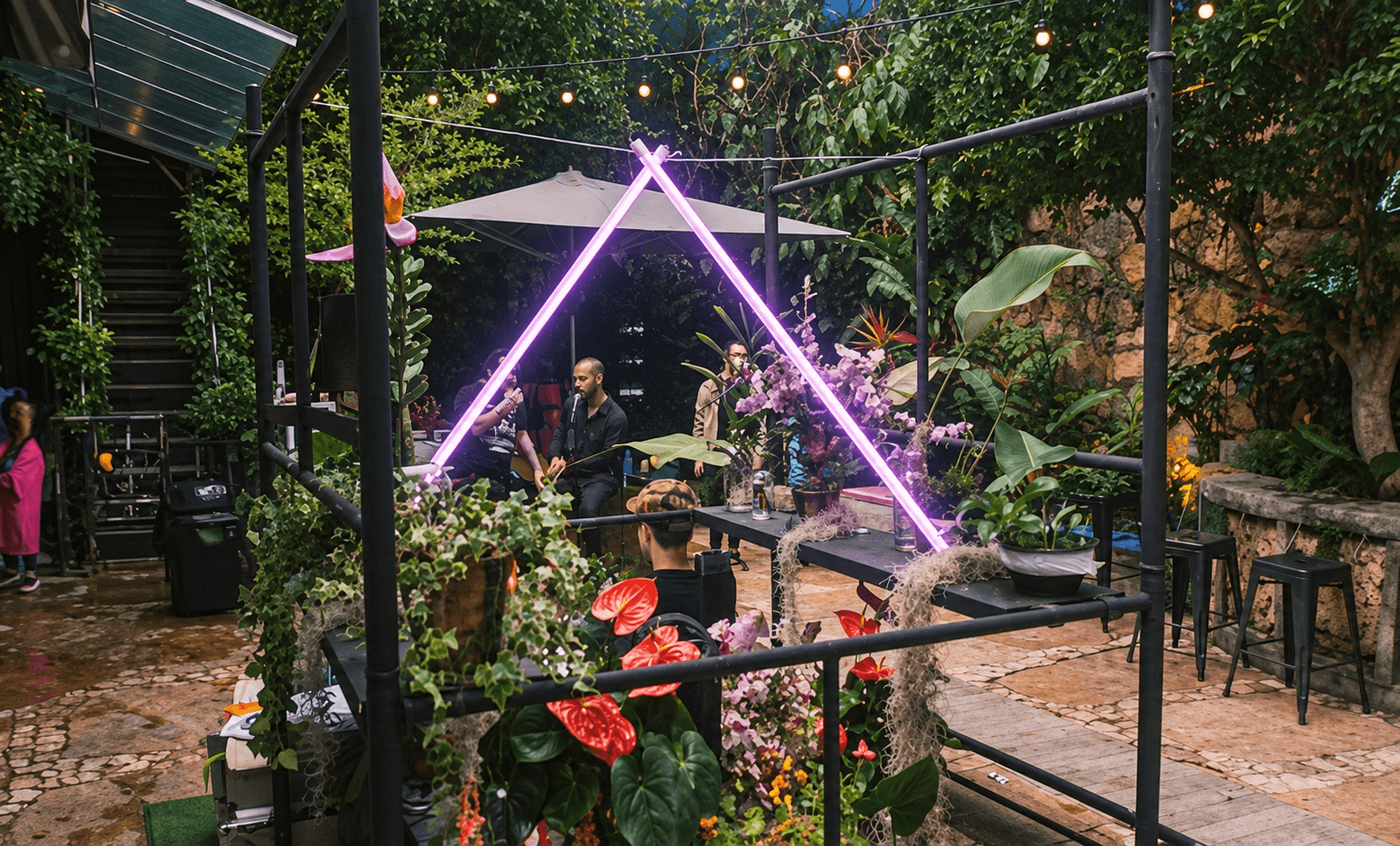 Illuminated triangular installation in the garden at Love na Casa Rosa.